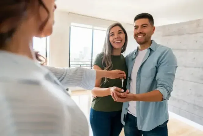 Real estate agent handing keys to happy homeowner